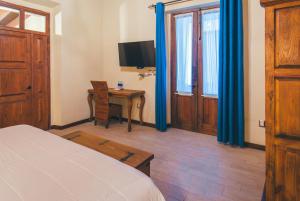 TV a/nebo společenská místnost v ubytování Hotel Boutique Casa Altamira