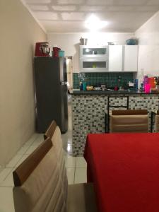 eine Küche mit einem Kühlschrank sowie einem Tisch und Stühlen in der Unterkunft Casa da Mari in Petrolina
