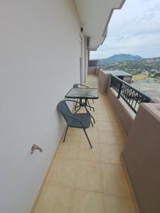 a balcony with a table and chairs on it at Angel Rooms in Yiofirákia