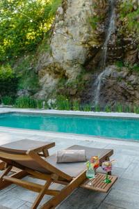 a wooden chaise lounge next to a swimming pool at Pensiunea Apuseni Wild in Remeţi