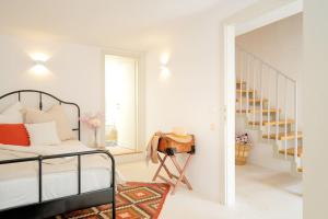 a white bedroom with a bed and a table at Villa Dida Hvar in Hvar