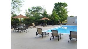 a patio with tables and chairs and a pool at Holiday Inn Akron-West by IHG in Montrose