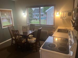 a kitchen with a table and a stove and a sink at Mount Jefferson View in Randolph