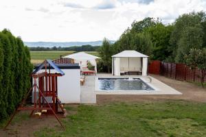 a backyard with a pool and a gazebo at Ella in Velika