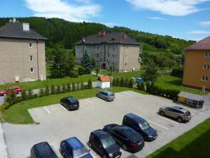 a group of cars parked in a parking lot at Apartmán Family in Liptovský Mikuláš