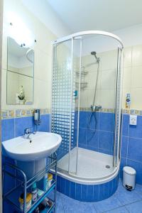 a bathroom with a sink and a shower at Apartmán Family in Liptovský Mikuláš