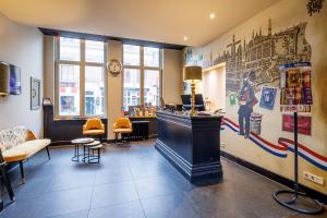 a bar in a restaurant with a mural on the wall at Grand Hotel Alkmaar in Alkmaar