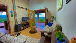 Uma TV ou centro de entretenimento em Casa de Campo Araxá na montanha com piscina