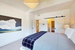 a bedroom with a bed and a painting on the wall at Gem State Getaway in Boise