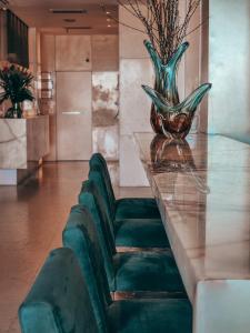 a table with a green chair and a vase on it at Sol Ipanema Hotel in Rio de Janeiro