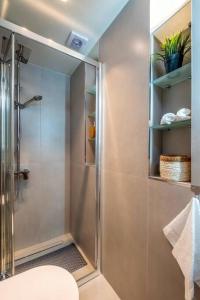 a shower with a glass door in a bathroom at Cozy Nest at Acropolis Footsteps in Athens