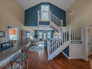 a living room with a staircase in a house at The Water Bear in Topsail Beach
