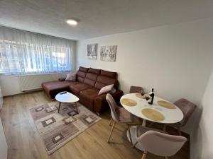 a living room with a couch and a table at Brand new apartment in Banja Luka