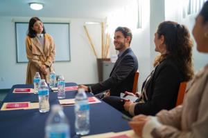 a group of people sitting around a table in a meeting at Hotel Suites Corazón Mexicano in Guanajuato