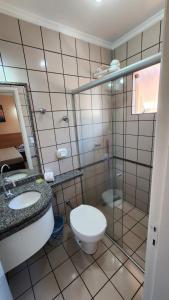 ein Bad mit einem WC und einer Glasdusche in der Unterkunft diRoma Fiori - Apartamentos JN in Caldas Novas