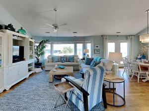 a living room with a couch and a table at The Shell Collector in Surf City