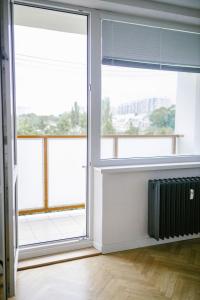 an empty room with windows and a radiator at Elegantný byt v srdci Košíc in Košice