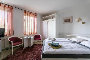 Rúm í herbergi á Hotel Panorama