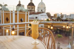 a drink sitting on a table on a balcony at Sophia Hotel in Cartagena de Indias