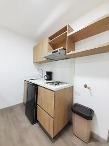 a small kitchen with a sink and a stove at MEDELLIN CÓMODOS APARTAESTUDIOS in Medellín