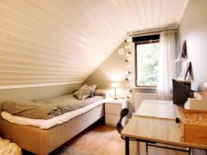 a bedroom with a bed and a window and a table at 6 person holiday home in TORSBY in Torsby