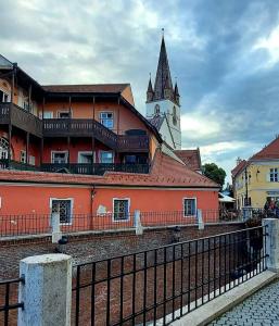 a building with a clock tower on top of it at Marian House in Sibiu