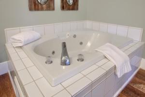 a white bath tub with a sink and towels at NEW! Yosemite Mountain villa, stunning views -more in Oakhurst +55 photos
