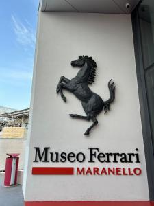 a sign with a horse on the side of a gas station at Apartment Ferrari track in Fiorano Modenese