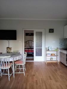 a living room with a table and chairs and a bedroom at Bike&Night in Baracska +42 photos