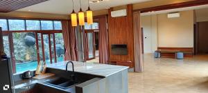 a kitchen with a sink and a counter top at Otto Guest House Sukawati in Saba