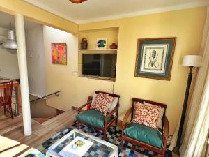 a living room with two chairs and a table at Pato’s Guest House in Mendoza