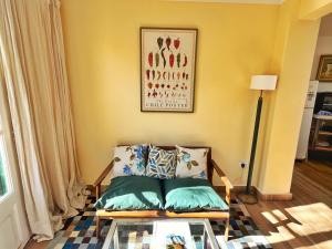 a living room with a couch and a glass table at Pato’s Guest House in Mendoza