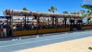 a restaurant with flowers and umbrellas on a beach at Sunrise Hotel Cameria in Durrës