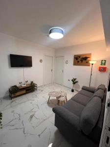 a living room with a couch and a flat screen tv at Old Port la Marina - Luna in Mazara del Vallo