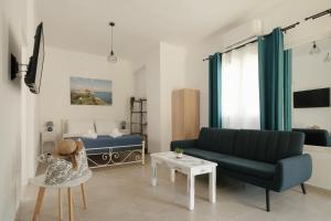 a living room with a couch and a bed at Agatha's central bright modern luxury apartment-2 in Perítheia