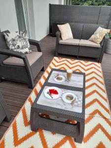 a coffee table with a plate of food on it at Nadmorskie Apartamenty w Gąskach in Gąski