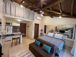 una grande camera da letto con un letto e una cucina di Lofts Asa Delta apartamento com cozinha a Ilhabela