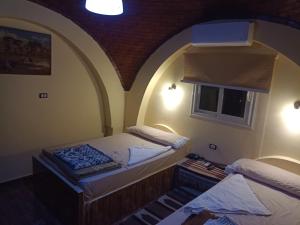 A bed or beds in a room at Rahala Safari Hotel