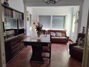 a living room with a table with a vase of flowers on it at Ca la conxita in Tona