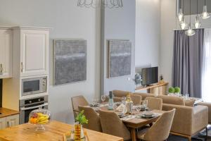 a dining room and living room with a table and chairs at Villa Hope in Chania in Mourniaí