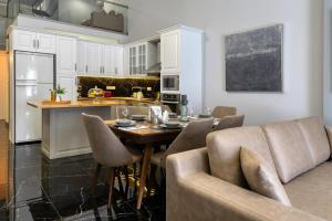a kitchen and dining room with a table and chairs at Villa Hope in Chania in Mourniaí