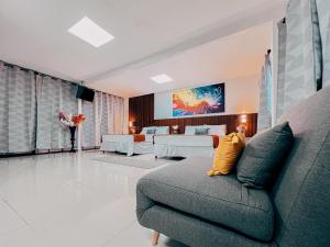 a living room with a couch and a bedroom at Hotel San Angelo in Concepción de Ataco