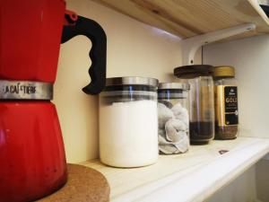 a counter with two containers of milk on a shelf at Botanic Avenue Hostel less than a mile from the City Centre in Belfast