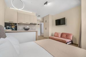 Zimmer mit einem Bett und einem Sofa sowie einer Küche in der Unterkunft Golden View with Balcony in Ammoudara