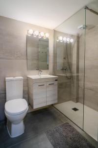 a bathroom with a toilet and a sink and a shower at Lazaros 1BDR Suite 3 min walk to Finikoudes beach in Larnaca