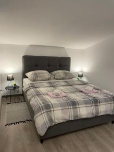 a bedroom with a large bed with two pillows at Apartments Dora in Poreč