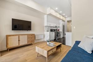 a living room with a blue couch and a table at Central King Studio in Montreal