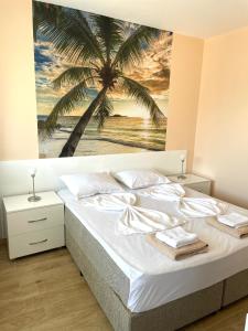 a bedroom with a palm tree mural on the wall at Palms Studio in Sozopol, with free parking in Sozopol