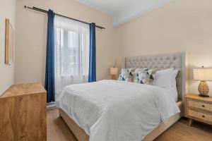 a bedroom with a large bed and a window at City Center 2BR Condo in Montreal