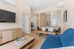 a living room with a couch and a table at City Center 2BR Condo in Montreal